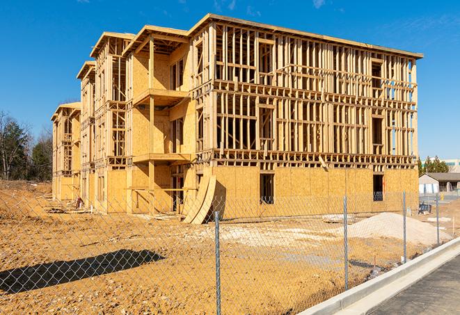 a temporary chain link fence winding around a construction site, outlining the project's progress in Kersey, CO